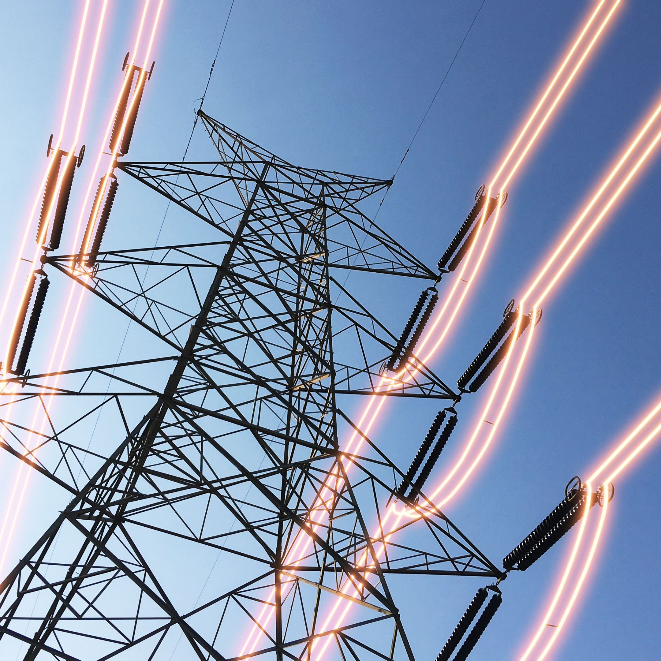 Electricity transmission towers with glowing wires